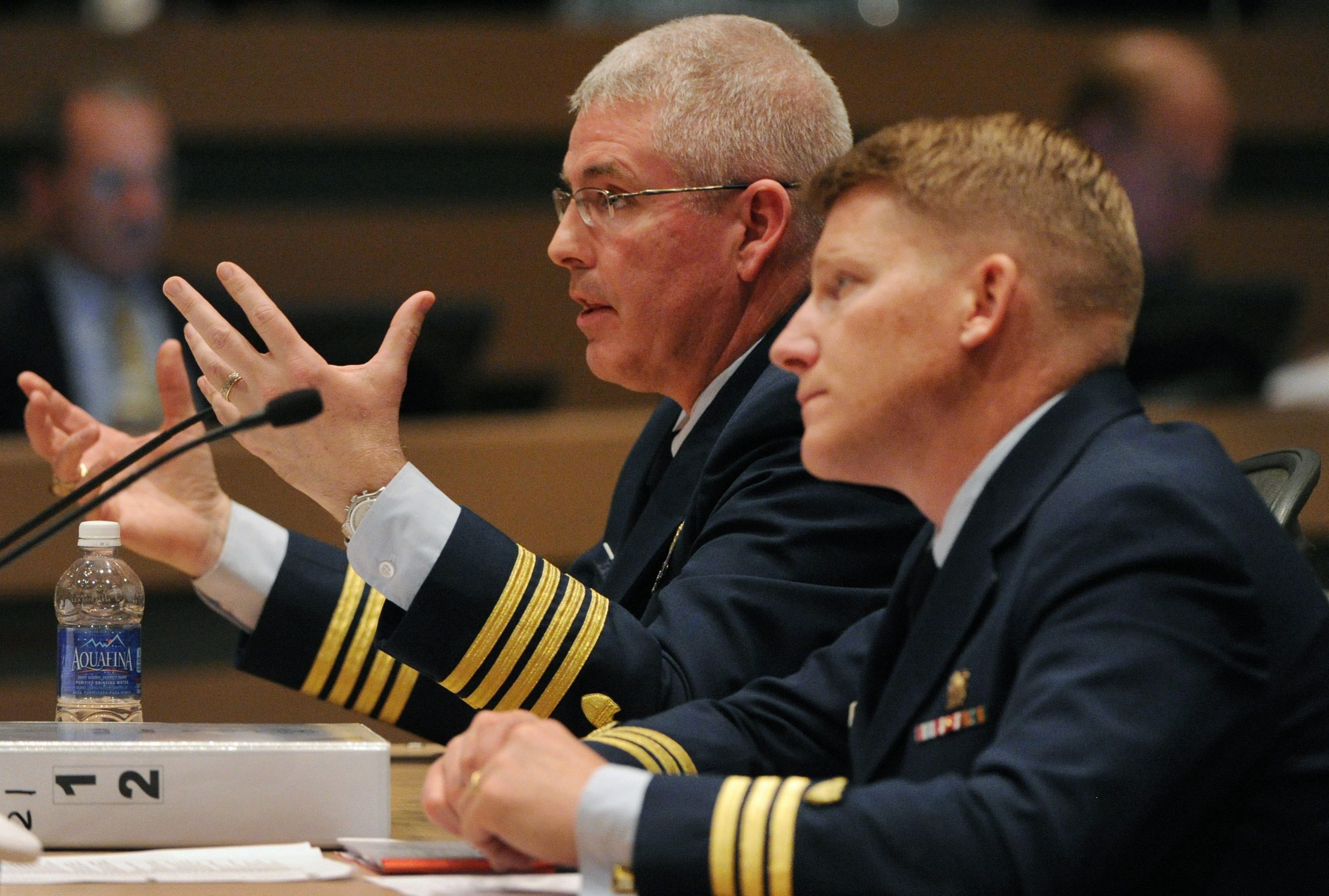 Capt. Paul Mehler III, left, commander of Coast Guard Sector Anchorage, testifies on Wednesday, May 29, 2013, during the formal marine casualty investigation hearing into Shell's conical drilling rig Kulluk grounding on Sitkalidak Island, Alaska, during severe weather on Dec. 31, 2012. Coast Guard lawyer Cmdr. William Dwyer listens at right. (Bill Roth, Pool, Anchorage Daily News/AP)