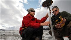 PhD student Matt Beedle (left) and professor Brian Menounos measure changes in glacier thickness using GPS.(Courtesy University of Northern British Columbia)
