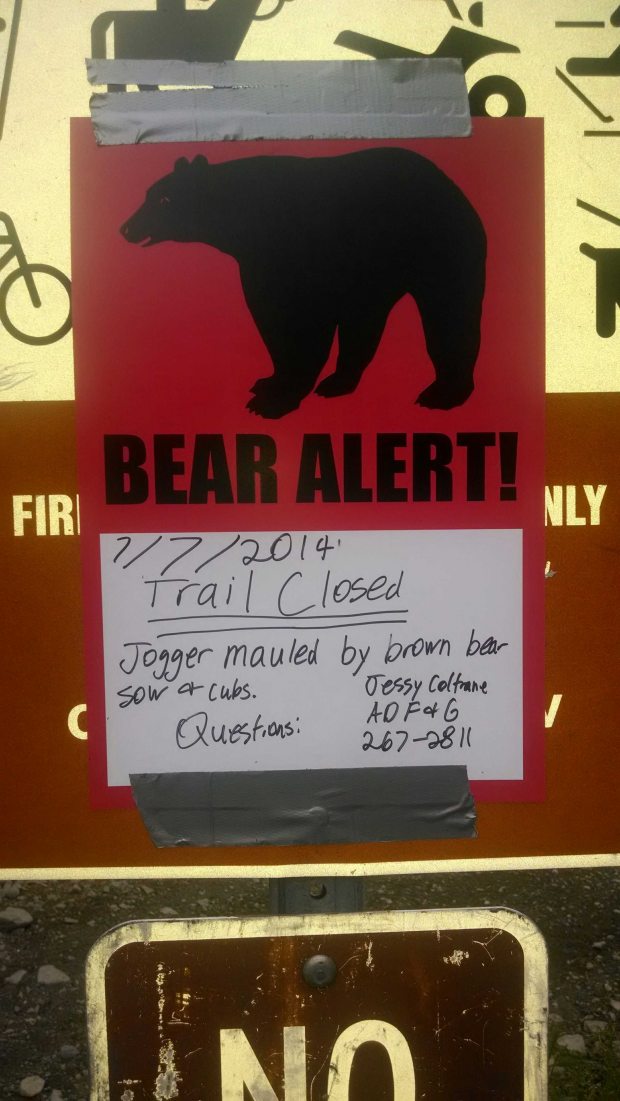 A sign hangs at the Bird Valley trailhead along Alaska's Turnagain Arm on July 7, 2014, warning people of a recent bear mauling in the area. (Craig Medred / Alaska Dispatch)