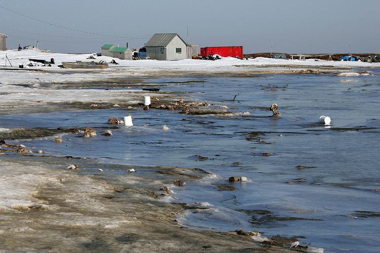 Melting permafrost is eroding land in Alaska villages like Newtok (pictured above). (Al Grillo/AP)