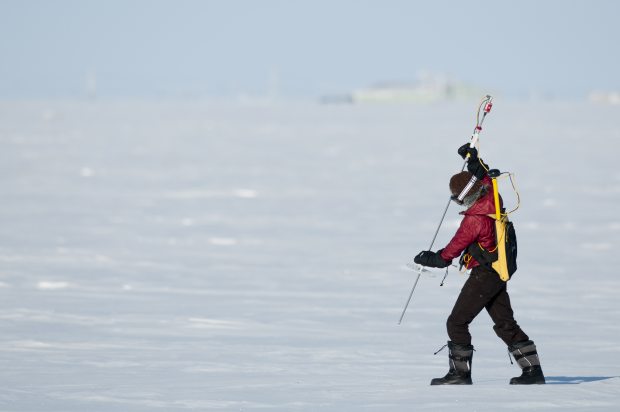 Melinda Webster takes snow depth measurements using an automated snow depth probe. The ground measurements were used to validate NASA's airborne measurements of snow depth. (Chris Linder / University of Washington)