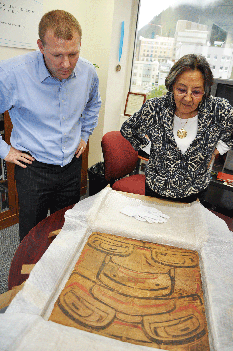 Sealaska Heritage Institute (SHI) Chief Operating Officer Lee Kadinger and (SHI) President Rosita Worl examining an artifact that was brought back to Alaska through auction. (Kathy Dye /Sealaska Heritage Institute )