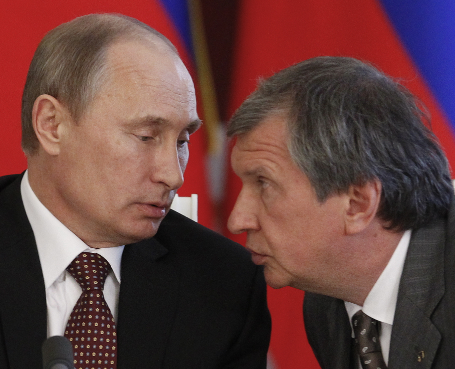 Russian President Vladimir Putin, left, and CEO of state-controlled Russian oil company Rosneft Igor Sechin, at a signing ceremony in 2013. (Maxim Shemetov/ AP)