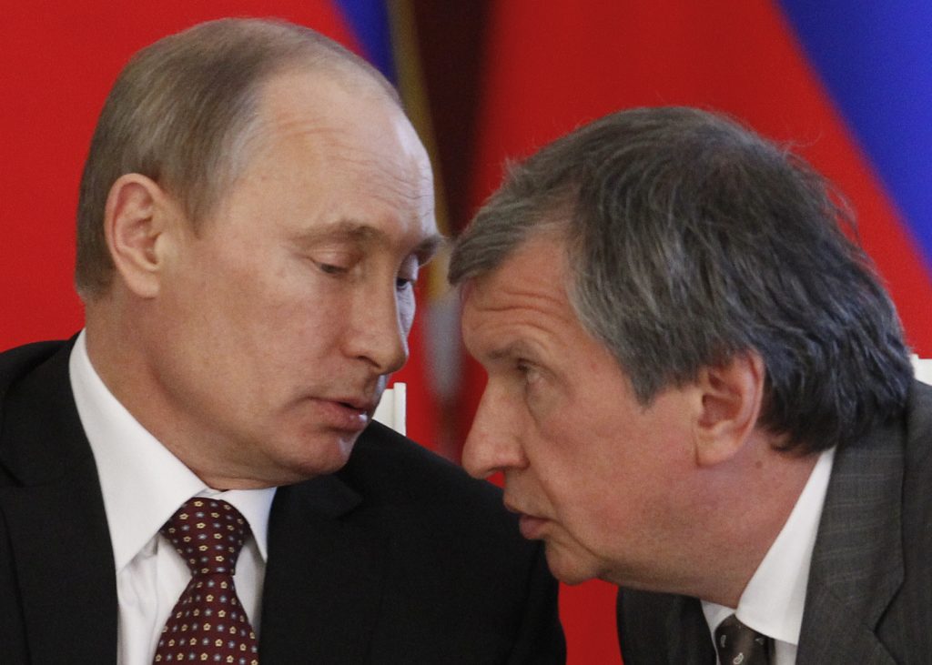 Russia's President Vladimir Putin (L) talks to Rosneft President and Chairman of the Management Board Igor Sechin in 2011. (Maxim Shemetov / AFP / Getty Images)