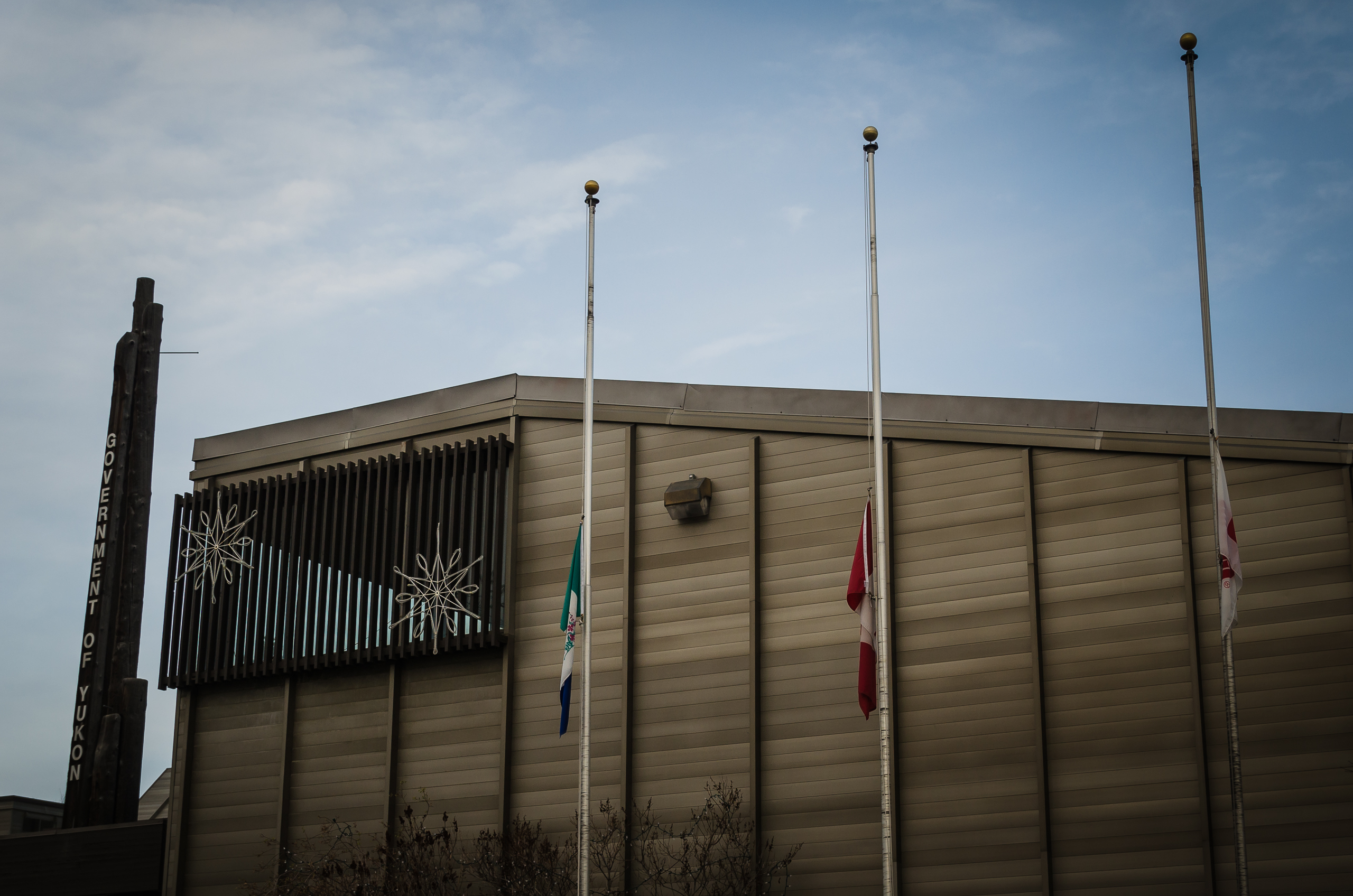 Flags in front of the main Yukon Government Building and Yukon Legislative Assembly in Whitehorse flew at half-mast on Wednesday after the Ottawa attack. (Yukon Government)
