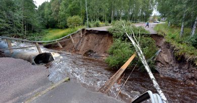 A rain-swollen river washed away the road and felled trees in Kristinehamn, western Sweden, on August 22, 2014. (Johan Nilsson/AFP/Getty Images)