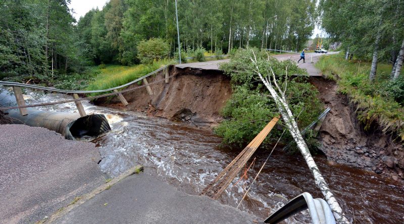 A rain-swollen river washed away the road and felled trees in Kristinehamn, western Sweden, on August 22, 2014. (Johan Nilsson/AFP/Getty Images)