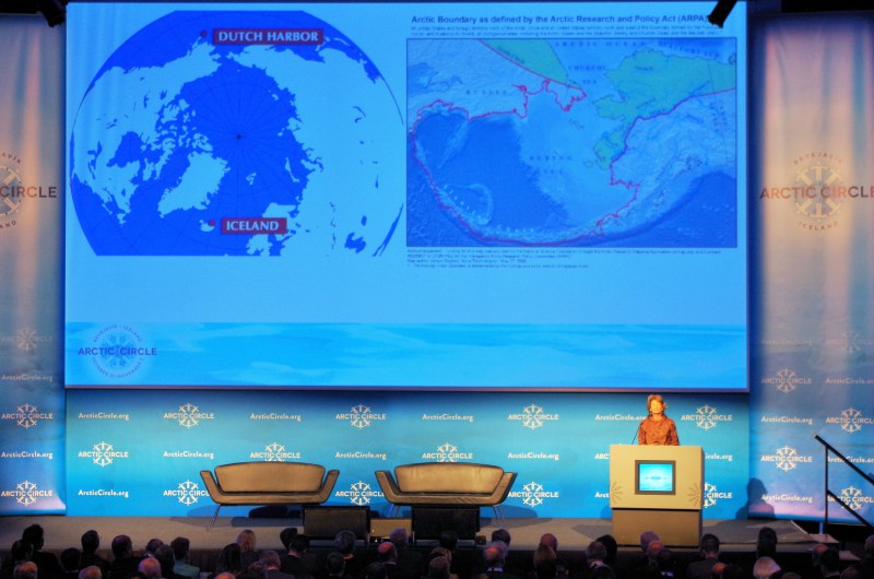 U.S. Senator Lisa Murkowski addresses Arctic Circle 2014 in Reykjavik, Iceland, with a map behind her of two polar opposite cities in the Arctic. (Mia Bennett)