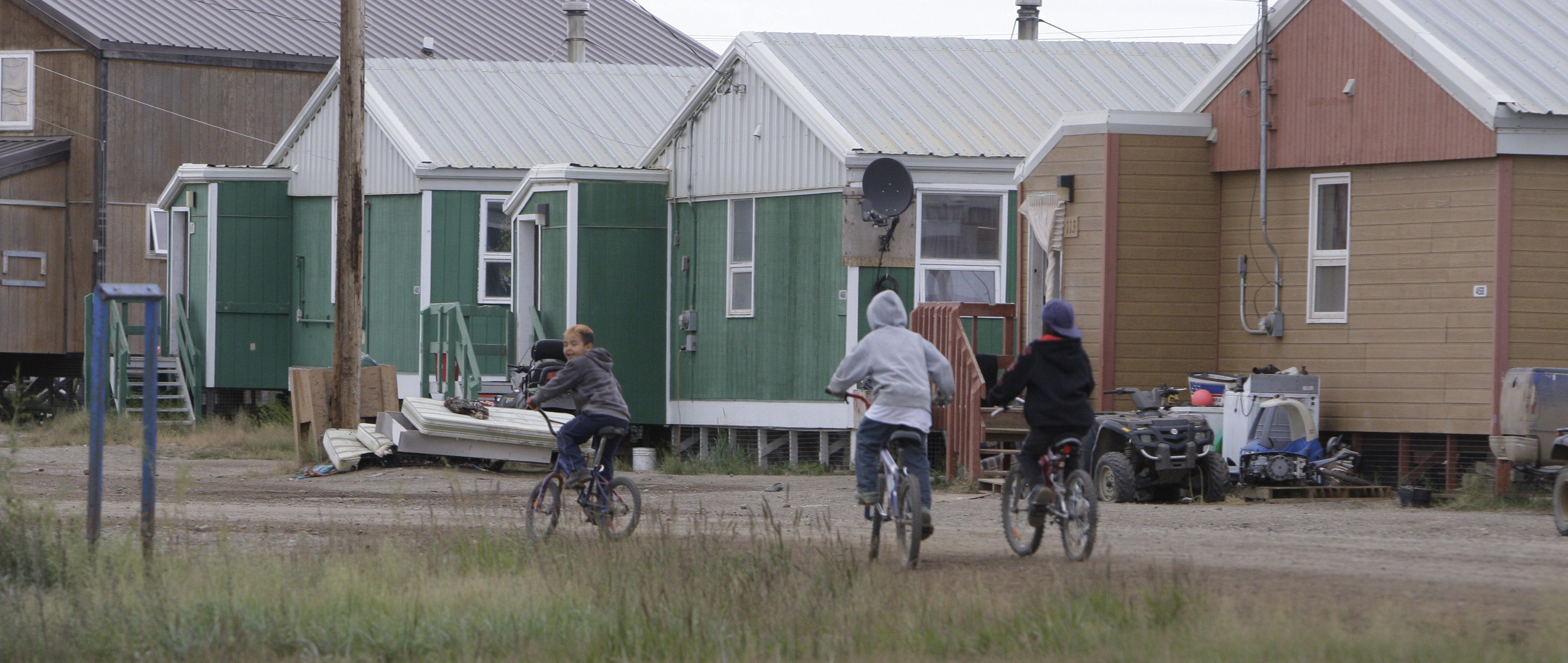 Tuktoyaktuk (pictured above) in Canada's Northwest Territories. Rising seas from global warming and land sinking as permafrost thaws are threatening the Arctic community. A recent study suggests governments need policies to address climate migration from around the world. (Rick Bowmer/AP)