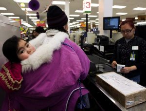 A mother pays for groceries in Baker Lake, Nunavut on March 25, 2009. Canada's auditor general said this year that the federal government can't tell if northerners are reaping the full benefit of a program aimed at helping to offset the high cost of food in the North. (Nathan Denette / The Canadian Press)