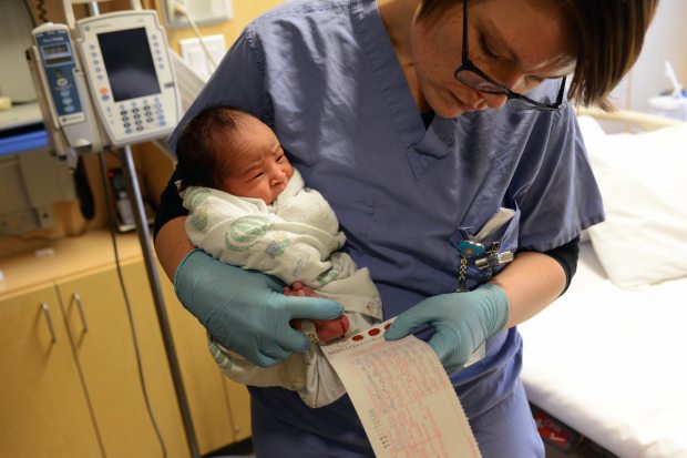 Postpartum nurse Elisa See collects blood samples from one-day-old Bryce Jones on Monday afternoon, Nov. 24, at Alaska Native Medical Center. The blood was drawn to screen for 50 conditions including CPT1A, which occurs in some Alaska Native people and other Arctic indigenous people. If undetected, CPT1A Arctic variant can have serious health consequences. A new and improved test, expected to be implemented next year, will do a better job of finding CPT1A Arctic variant. (Erik Hill / Alaska Dispatch News)