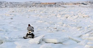 A snowmobiler makes his way through the ice on Frobisher Bay outside of Iqaluit. Canada's Arctic capital of 7,000, like other Arctic communities, is growing rapidly, in part due to migration from smaller communities, according to the second Arctic Human Development Report. (Sean Kilpatrick/Canadian Press)