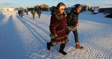 Millie Hawley and Interior Secretary Sally Jewell walk down the main street in the Inupiat village of Kivalina, Alaska on Monday, Feb. 16, 2015. The village is threatened by coastal erosion of the long barrier island between the Chukchi Sea and a lagoon at the mouth of the Kivalina River. (Bill Roth / Alaska Dispatch News)