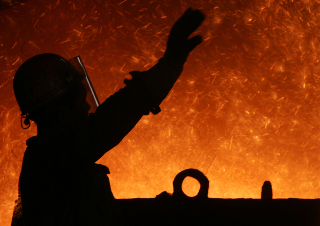 A worker in front of a blast furnace at an iron and steel factory in China. (China Photos/Getty Images)