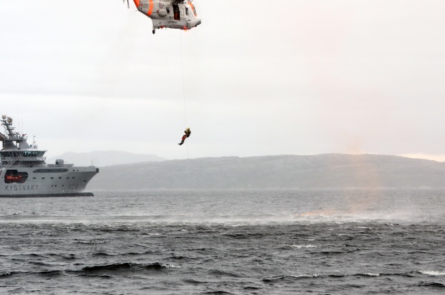 Exercise Barents includes search and rescue operations. Photo shows "KV Harstad" and a Norwegian rescue helicopter involved in a similar exercise in 2013. (Jonas Karlsbakk/Barents Observer)