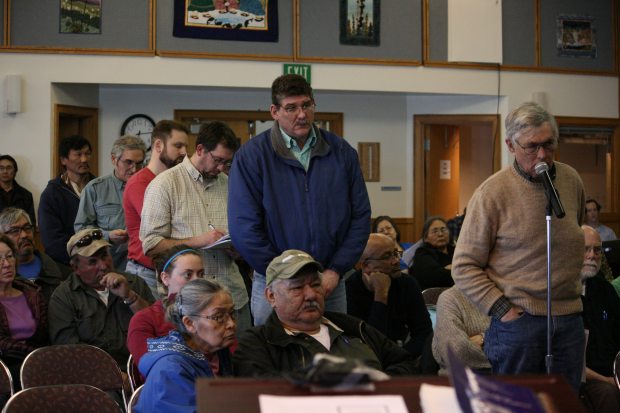 Dozens of Bethel residents and people from nearby villages packed the Yupiit Piciryarait Cultural Center on Monday evening for a town hall meeting on the prospect of a liquor store in Bethel. Longtime resident Bob Carlson, at microphone, was the first of residents and community leaders who lined up to ask questions of Cynthia Franklin, ABC Board director. (Lisa Demer / Alaska Dispatch News)