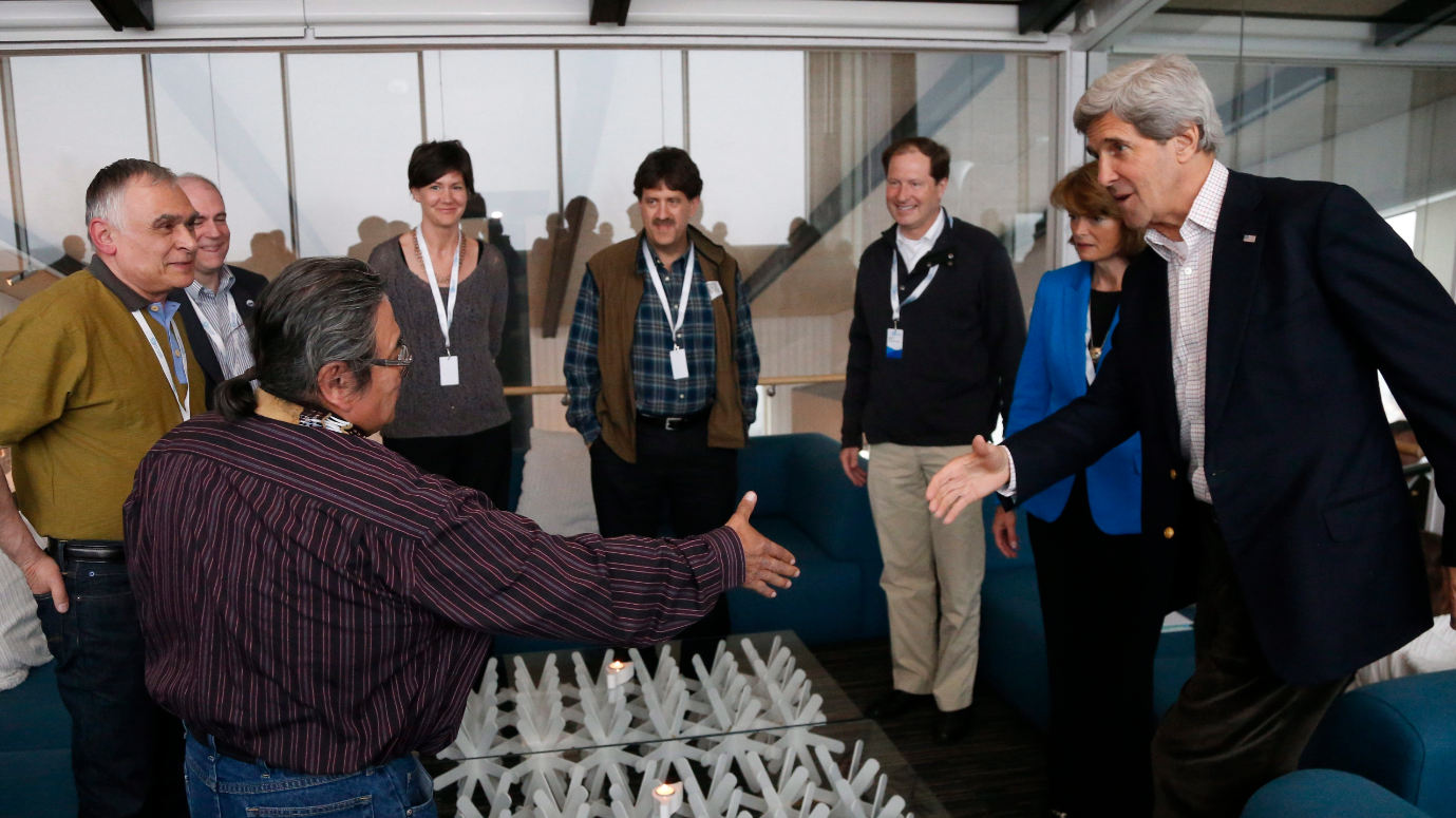 U.S. Secretary of State John Kerry (right) reaches out to shake hands with Michael Stickman, International Chair of the Arctic Athabaskan Council, in Kiruna, Sweden, Tuesday, May 14, 2013, during the Arctic Council ministerial. Stickman stressed the importance of keeping politics out of the Arctic Council during the ministerial meeting in Iqaluit on Friday. (Charles Dharapak/AP)