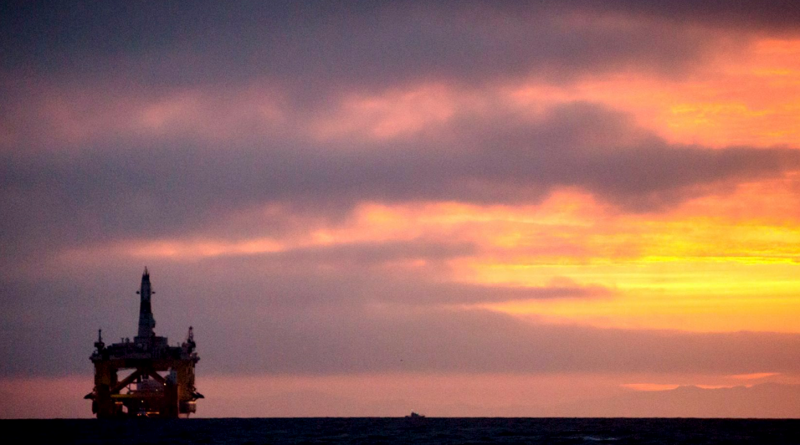 In this April 17, 2015 file photo, an oil drilling rig arrives aboard a transport ship at sunrise, following a journey across the Pacific in Port Angeles, Wash. Royal Dutch Shell hopes to use the rig for exploratory drilling during the summer open-water season in the Chukchi Sea off Alaska's northwest coast. (Daniella Beccaria/seattlepi.com via AP)