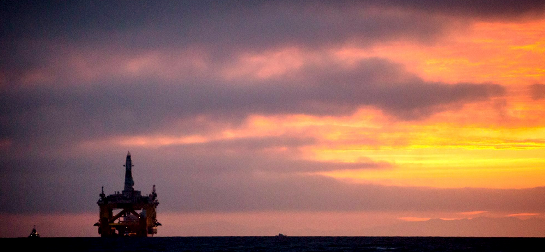 In this April 17, 2015 file photo, an oil drilling rig arrives aboard a transport ship at sunrise, following a journey across the Pacific in Port Angeles, Wash. Royal Dutch Shell hopes to use the rig for exploratory drilling during the summer open-water season in the Chukchi Sea off Alaska's northwest coast. (Daniella Beccaria/seattlepi.com via AP)