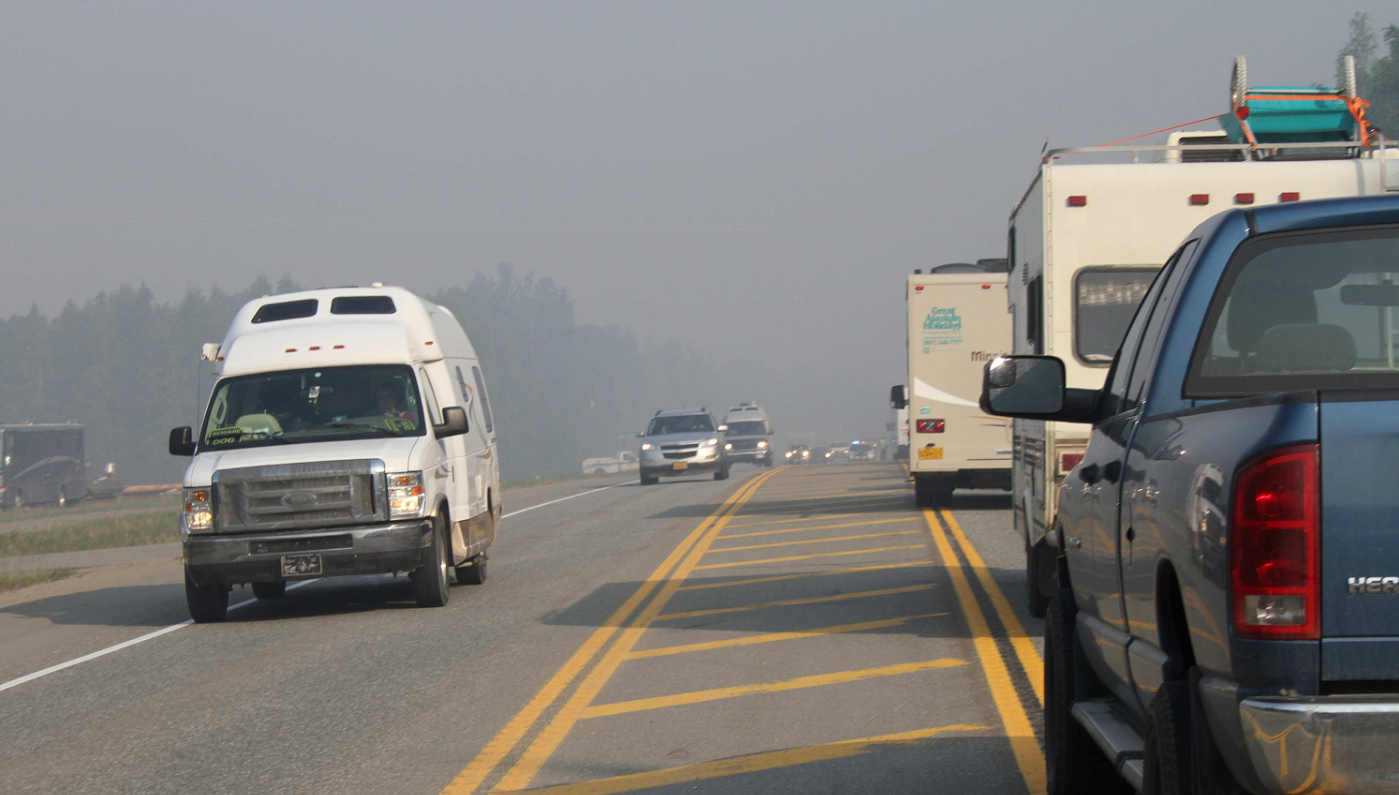 Drivers wait to be escorted through an active wildfire area near Willow Alaska on June 15, 2015. The fire has led to the voluntary evacuation of up to 1,700 structures and has struck the heart of sled dog country, including 15 or so mushers who call Willow home. (/Mark Thiessen/AP)