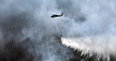 A “Bambi Bucket,” hanging from a helicopter releases hundreds of gallons of water onto the Stetson Creek Fire near Cooper Landing, Alaska on June 17, 2015. (Sgt. Balinda O’Neal/U.S. Army National Guard via AP)