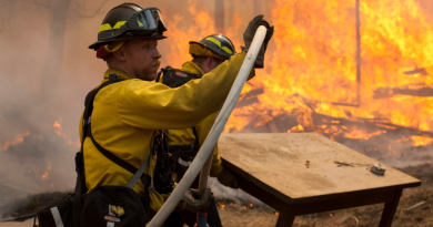 In this May 25, 2014 file photo, Central Emergency Services firefighter Dan Jensen maneuvers a hose into position to fight a portion of a wildfire in the Funny River community of Soldotna, Alaska. Wildfires are blistering Alaska forests with increasing frequency and intensity and forest managers and climate scientists are trying to explain why and predict what's next. One common factor associated with the increase, which doesn't bode well for 2015 or beyond, is warm weather, even if experts don't explicitly blame climate change. (Rashah McChesney/Peninsula Clarion via AP)