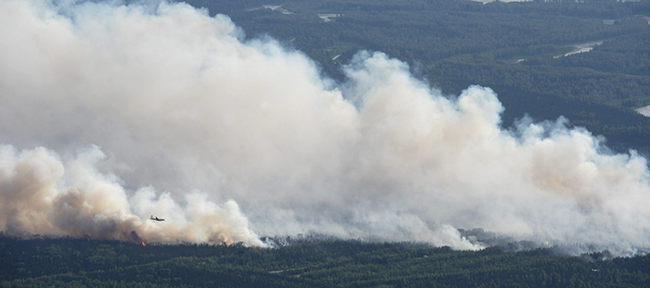 A State Division of Forestry air tanker works the Sockeye fire north of Kashwitna Lake on Sunday, June 14, 2015, near Willow, Alaska.  (Bill Roth / Alaska Dispatch News via AP)