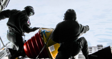 Two U.S. Coast Guard drop masters on an Arctic Domain Awareness flight push a weather buoy into the ocean north of Deadhorse on Tuesday, July 14, 2015. (Kamala Kelkar/Alaska Dispatch News)