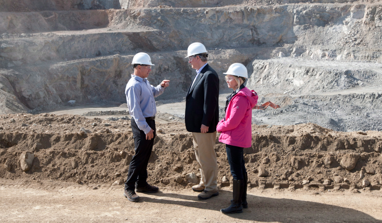 Canadian Prime Minister Stephen Harper and his wife Laureen talk with Capstone Mining CEO Darren Pylot infront of the Minto mine in Minto, Yukon Tuesday August 21, 2012. (Adrian Wyld/The Canadian Press)