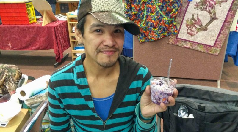 Wassillie Isaac Jr. of Bethel holds up akutaq, or Eskimo ice cream, that he made with whitefish that he netted, along with tundra berries. He wasn't allowed to sell it at Saturday Market in Bethel on July 25, 2015, because the fish wasn't commercially processed. (Lisa Demer / Alaska Dispatch News)