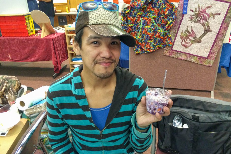 Wassillie Isaac Jr. of Bethel holds up akutaq, or Eskimo ice cream, that he made with whitefish that he netted, along with tundra berries. He wasn't allowed to sell it at Saturday Market in Bethel on July 25, 2015, because the fish wasn't commercially processed. (Lisa Demer / Alaska Dispatch News)