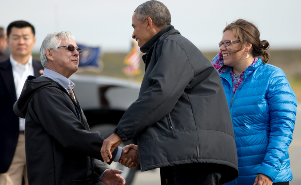 U.S. President Barack Obama is greeted in Alaska by Kotzebue mayor Maija Lukin, right, and Northwest Arctic Borough mayor Reggie Joule, left, as he arrives at Ralph Wien Memorial Airport, Wednesday, Sept. 2, 2015. Obama will talk Arctic issues with Nordic leaders this summer in Washington. (Andrew Harnik/ AP)