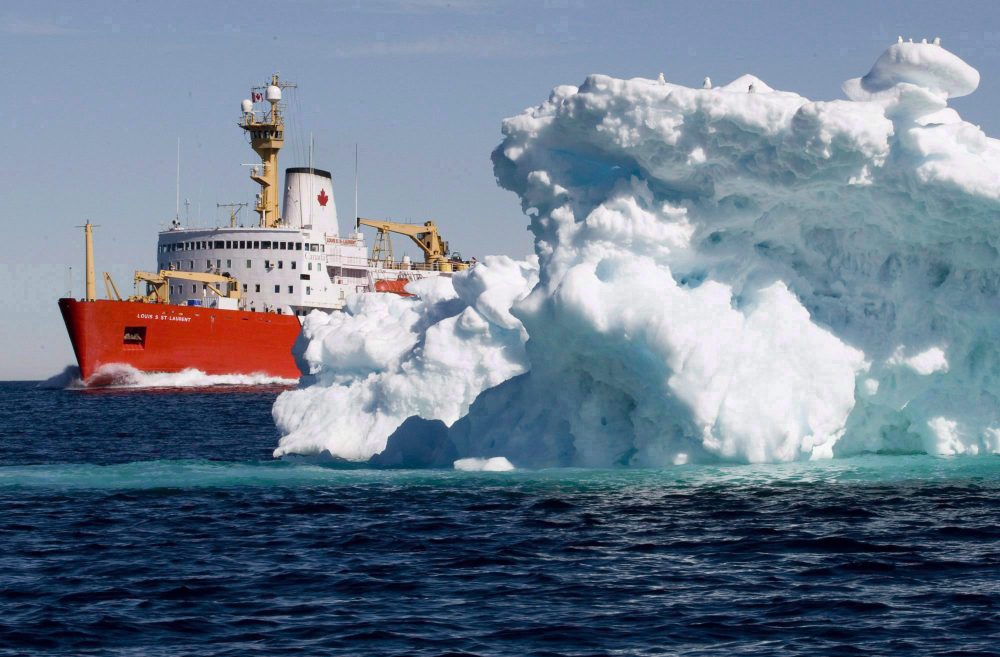 The Canadian Coast Guard icebreaker Louis S. St-Laurent sails past a iceberg in Lancaster Sound, Friday, July 11, 2008. (Jonathan Hayward/The Canadian Press)