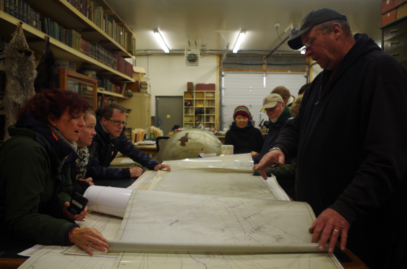 Reeves pointing out something on the map to the professors and students. (Mia Bennett)