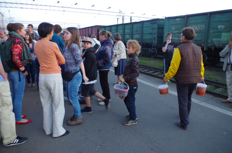 People selling raspberries and cloudberries on the platform in Svir, Russia. (Mia Bennett)
