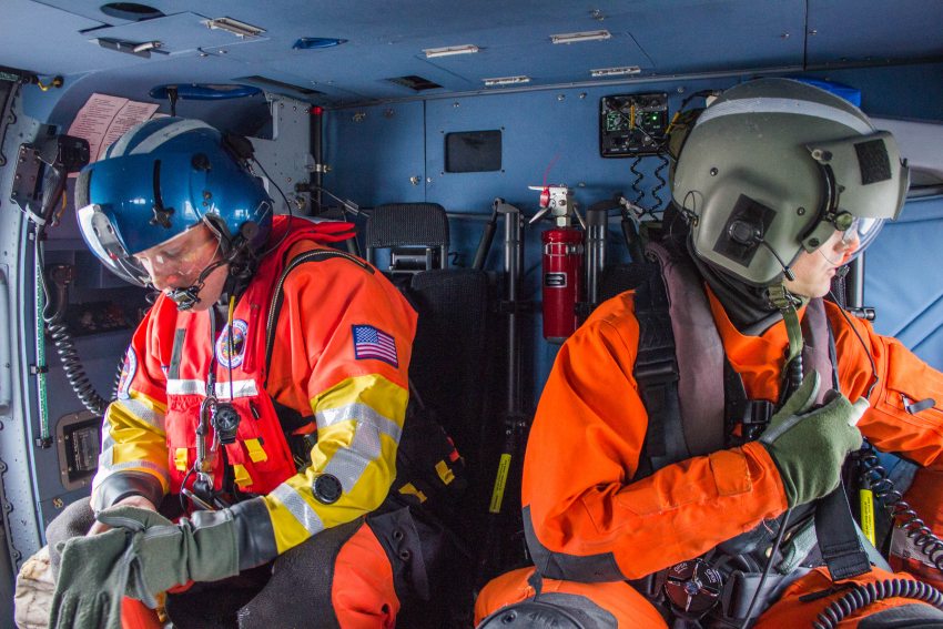 Aviation Survival Technician Micah Franklin, left, and Aviation Maintenance Technician Kyle Stalter are part of a crew of four aboard a Coast Guard Jayhawk helicopter during a flight flight near Prudhoe Bay on October 10. (Asaf Shalev / Alaska Dispatch News)