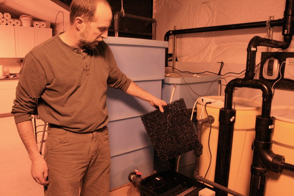 Bob White of the Yukon-Kuskokwim Health Corp. on Tuesday, Dec. 8, 2015. The corporation is testing systems in a Bethel warehouse for treating and reusing household gray water from the laundry, shower and bathroom sink. (Lisa Demer/Alaska Dispatch News)