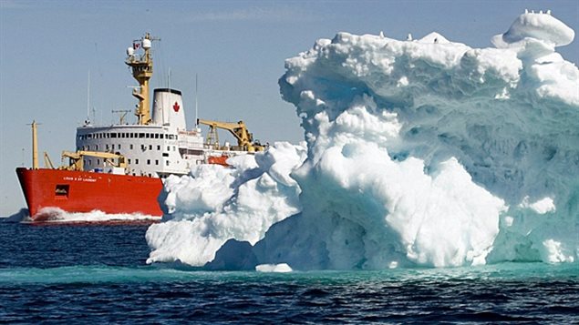The Canadian Coast Guard icebreaker Louis St. Laurent sails past a iceberg in Lancaster Sound in July 2008. (Jonathan Hayward/The Canadian Press)