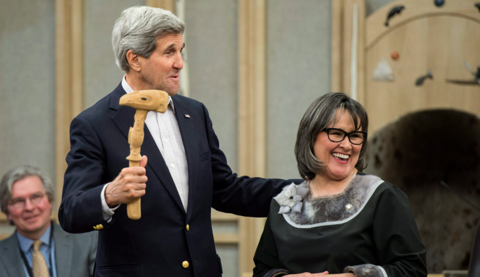 U.S. Secretary of State John Kerry receives the Arctic Council gavel from Leona Aglukkaq, then Canada's Minister for the Arctic Council, in Iqaluit, Nunavut on April 24, 2015. (Paul Chiasson/The Canadian Press)