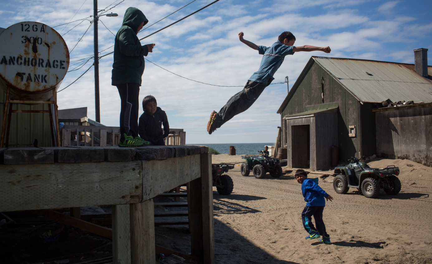 Village children jump off of a loading dock on July 8, 2015 in Shishmaref, Alaska. Earlier this year the Obama administration approved Shell Oil to begin drilling for oil in Arctic regions, including the Chukchi sea, worrying locals who live in the region and disappointing conservationists. (Andrew Burton/Getty Images)