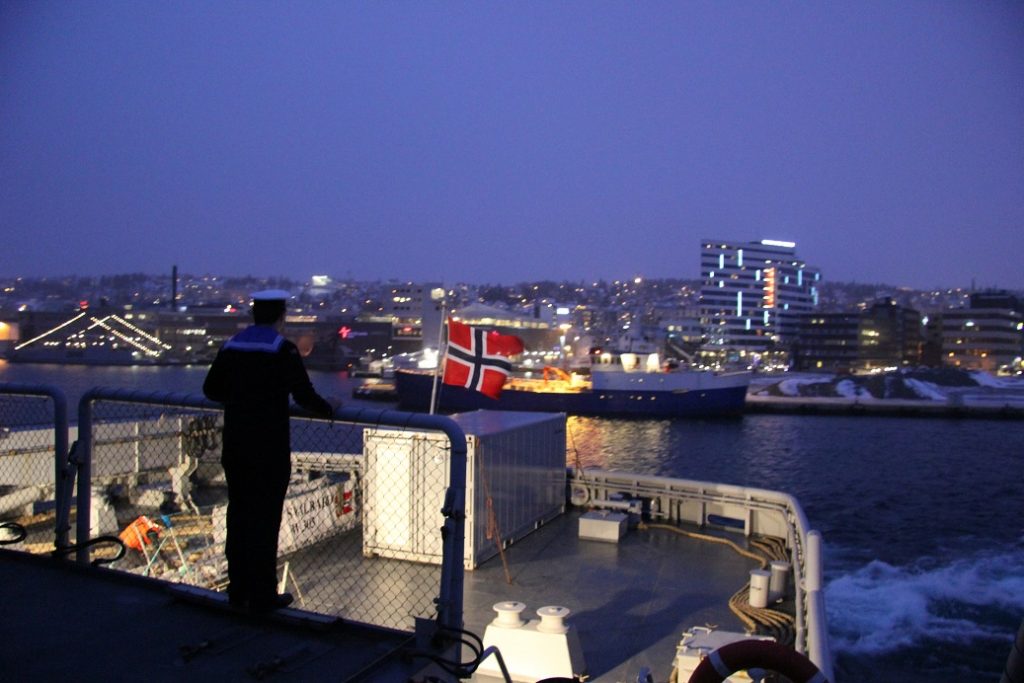 A sailor looks out at Tromso, Norway from the Norwegian icebreaker KV Svalbard. (Eilis Quinn/Eye on the Arctic) 