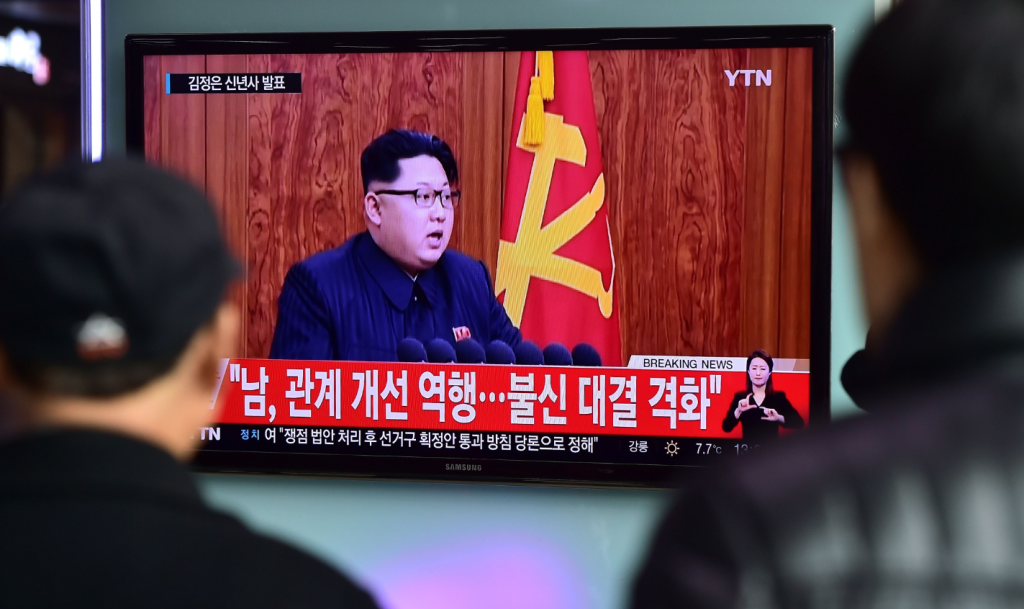 Commuters walk past a television screen showing a broadcast of North Korean leader Kim Jong-Un's New Year speech, at a railroad station in Seoul on January 1, 2016. North Korea recently announced that it had signed the Svalbard Treaty. (Jung Yeon-Je/AFP/Getty Images)