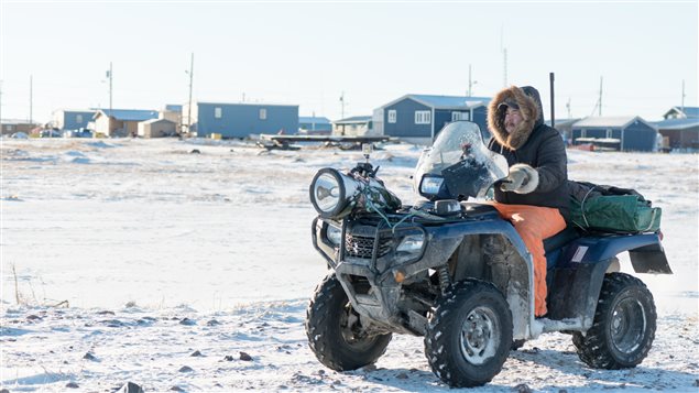 Polar bear patrol guard Leo Ikakhik in Arviat, Nunavut. The ATV along with noisebakers, bean bag guns, and other devices are used to scare the bears away from town. Firearms are now a last resort. © Elizabeth Kruger/WWF-Canada