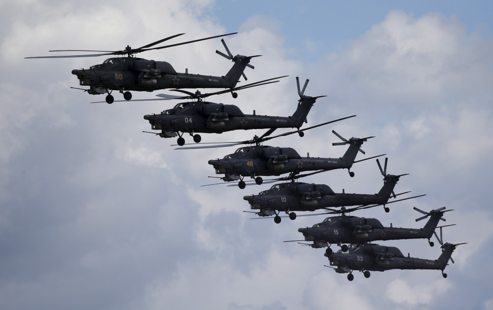 Russian Mi-28N from the Berkuty (Golden Eagles) helicopter display team fly in formation during the "Aviadarts" military aviation competition at the Dubrovichi range near Ryazan, Russia, August 2, 2015. REUTERS/Maxim Shemetov