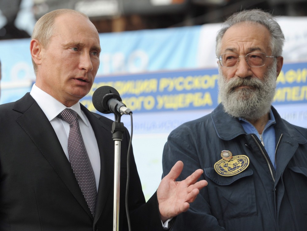 Russian President Vladimir Putin, left, speaks as Polar explorer and lawmaker Artur Chilingarov listens to him during a ceremony to launch the construction of Russias fourth Borei-class (Project 955A) ballistic missile submarine "Knyaz Vladimir" on Monday, July 30, 2012. (AP Photo/RIA-Novosti, Alexei Nikolsky, Presidential Press Service)