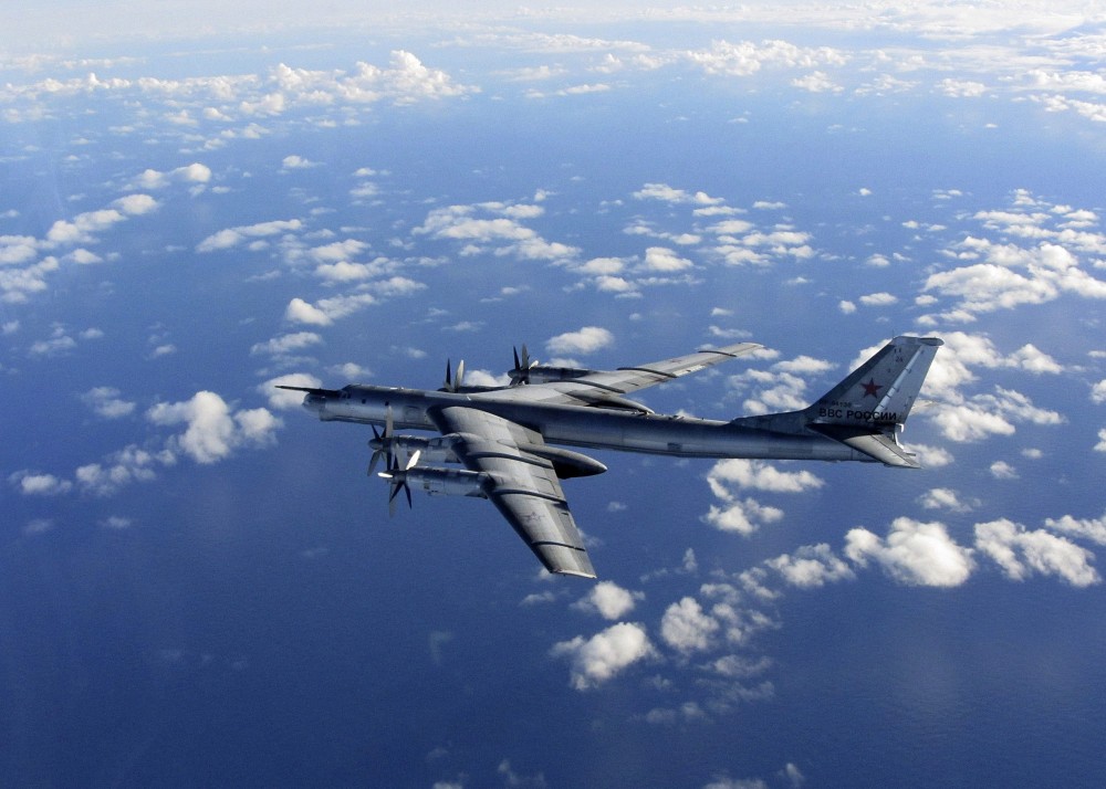 This is a Wednesday, Oct. 29, 2014 file photo provided by Britain's Royal Air Force of a Russian military long range bomber aircraft photographed by an intercepting RAF quick reaction Typhoon (QRA) as it flies in international airspace. (AP Photo/Royal AIr Force)