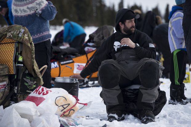 Musher Rick Casillo checks the heat on his cooker. Mushers in the Iditarod Trail Sled Dog Race came and went from the Rainy Pass checkpoint for much of the day Monday. Marc Lester / ADN