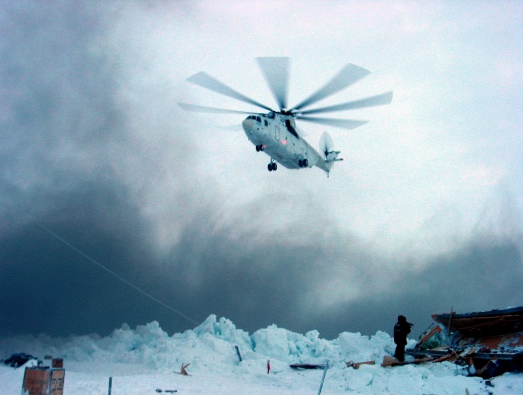 Russian Mi-26 helicopter lands on the iceberg where Severny Polyus-32 station was located with 12 Russian researchers huddled for three days in temperatures of minus 39 Celsius (minus 38 Fahrenheit) March 6, 2004. Helicopters plucked a team of scientists from deep within the Arctic Circle after their research station was crushed beneath a wall of ice. Vladimir Strugatskiy /REUTERS
