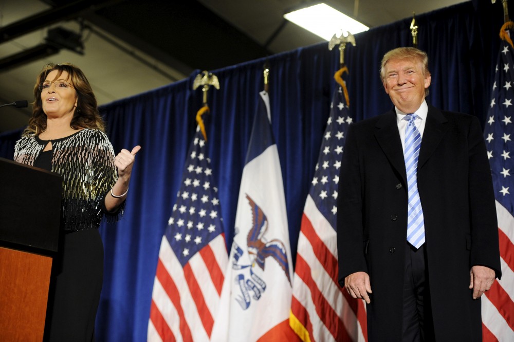 Former Alaska Gov. Sarah Palin (L) points to U.S. Republican presidential candidate Donald Trump (R) as she speaks after endorsing him for President at a rally at Iowa State University in Ames, Iowa January 19, 2016. Mark Kauzlarich /REUTERS