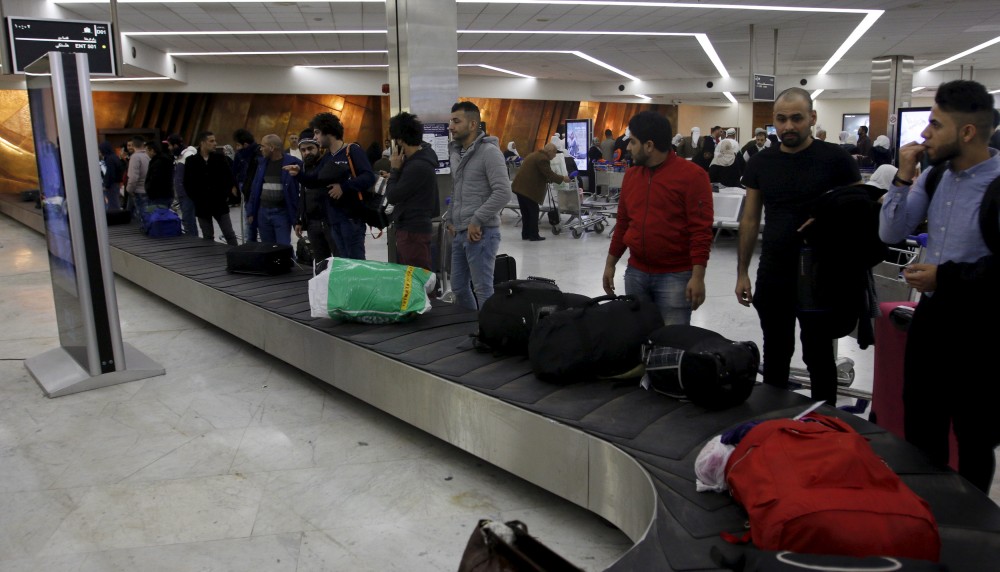 Iraqi refugees returning from Finland wait for their luggage at Baghdad airport, Iraq February 18, 2016. Khalid al Mousily/REUTERS